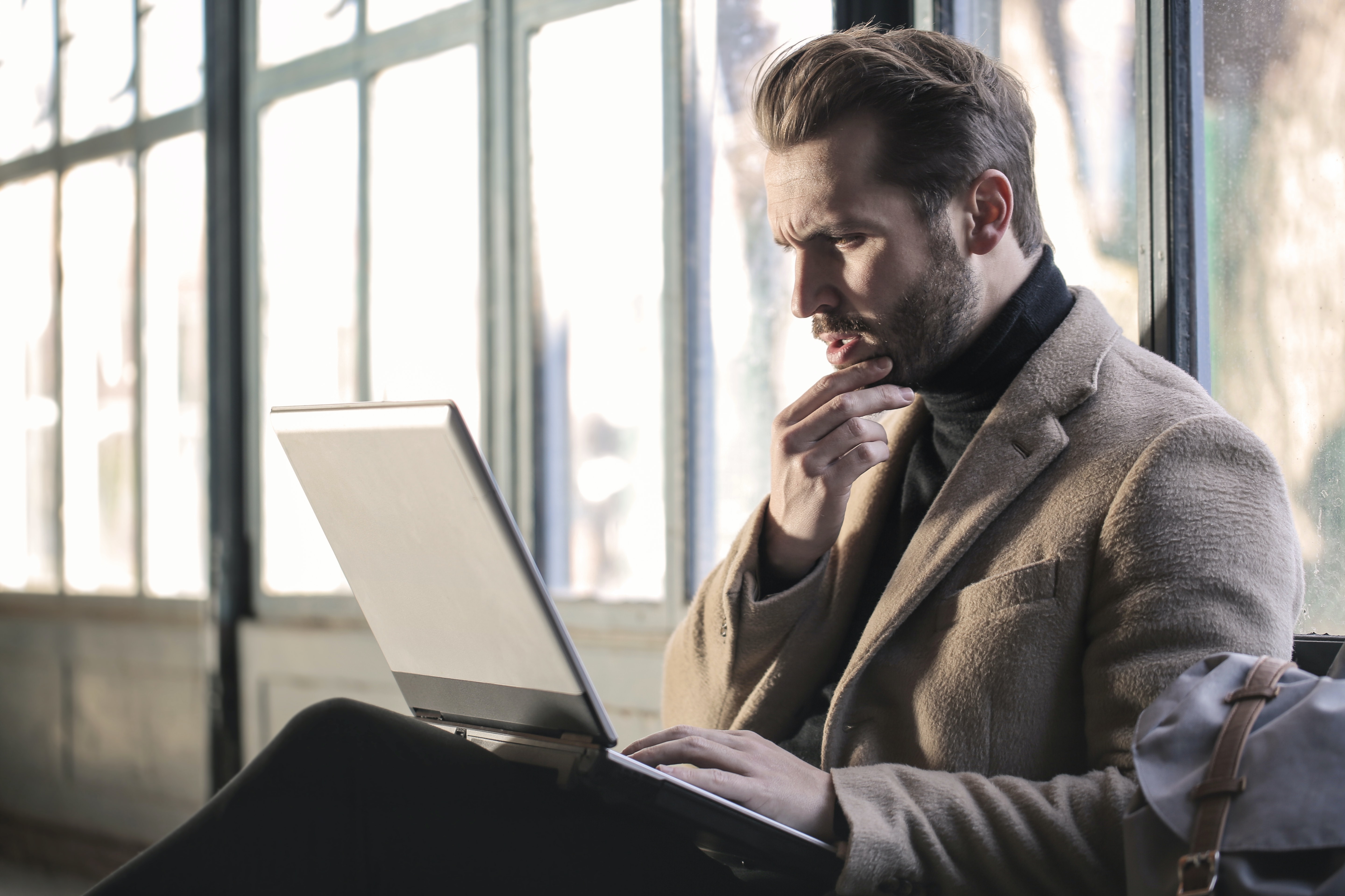surprised worker sitting with laptop